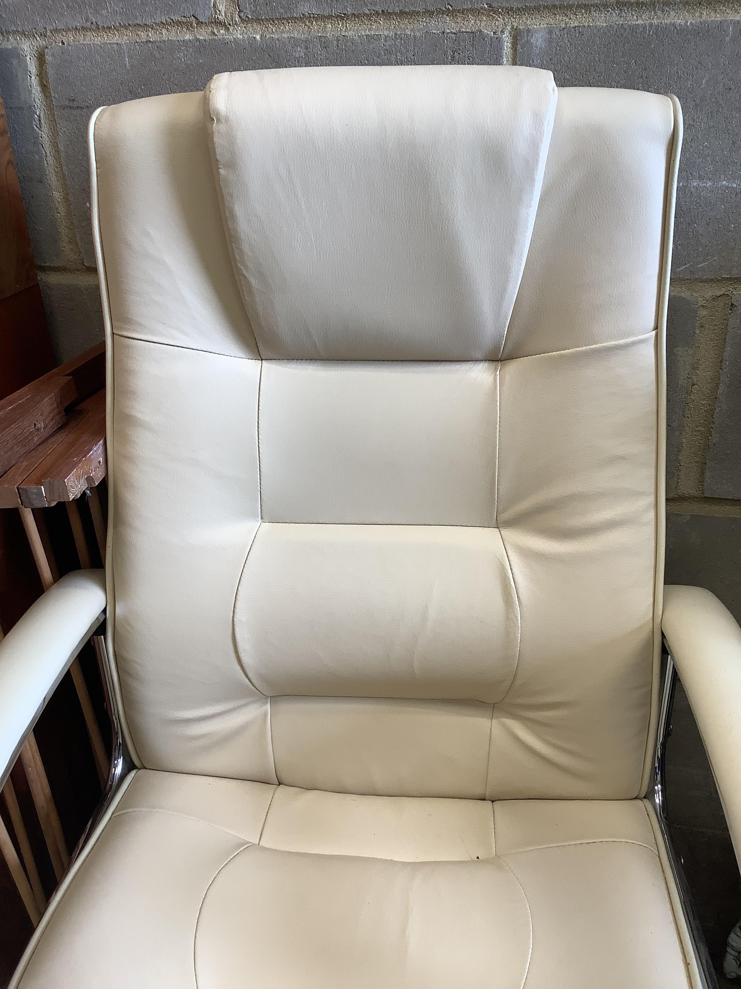 A modern white leather and chrome swivel desk armchair, width 63cm, height 106cm